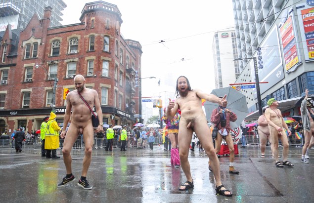 Jade Sambrook performing a side-glide à la Michael Jackson while walking naked with the TNTmen group along the route of the 2015 Toronto Pride Parade.