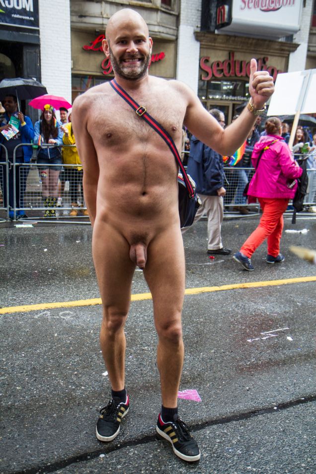 Jade Sambrook posing for a photo while nude in public along the route of the 2015 Toronto Pride Parade.
