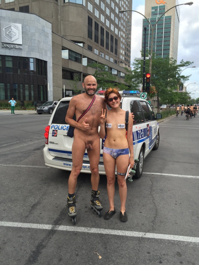 Jade Sambrook naked on rollerblades with a female skateboarder at the 2015 daytime edition of the World Naked Bike Ride in Montreal.